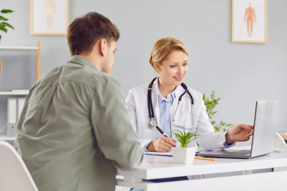 Male patient consulting with a doctor regarding TRT